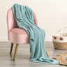 Indulge in the luxurious comfort of the Moss Seed Cotton Throw. Crafted with a supremely soft hand-feel, this throw offers a versatile color and texture that effortlessly enhances any space.