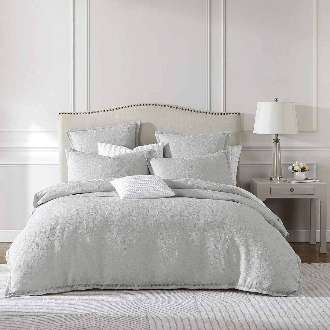 Create a traditional ambiance with the classic styling of Valentina. Delicate floral clusters are woven on a textured ground to create visual and tactile surface definition. The tonal silver braid provides an elegant finish.
