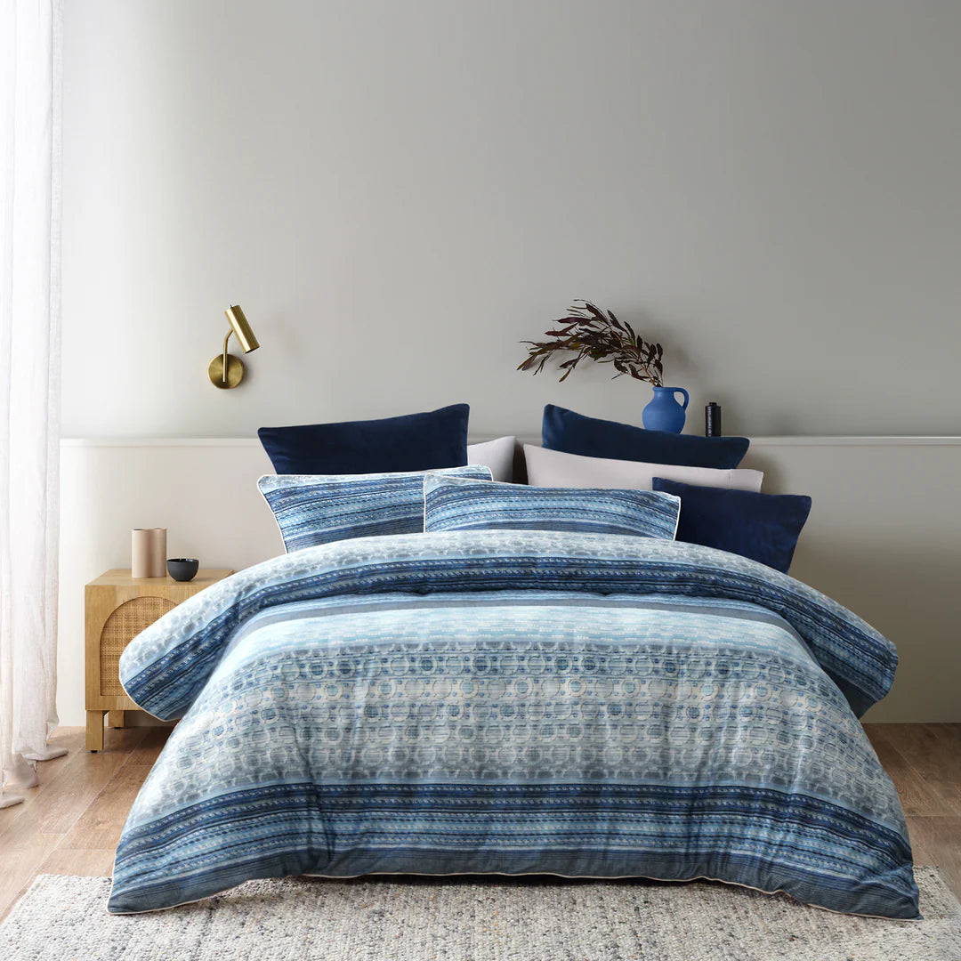 Brighten your space this winter with Amata. The use of all blue tones creates a sense of calm. The silky feel of soft cotton sateen fabric is perfect for cuddling up to in bed. Flawless piped edging in white allows for a beautiful contrast.