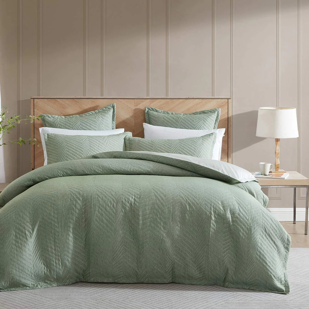Embrace the elegant simplicity of Monty Eucalyptus, a bedding masterpiece. This stunning design showcases asymmetrical vertical stripes artfully manipulated into a charming skewed chevron pattern.