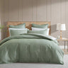 Embrace the elegant simplicity of Monty Eucalyptus, a bedding masterpiece. This stunning design showcases asymmetrical vertical stripes artfully manipulated into a charming skewed chevron pattern.