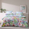 Parakeeta Aqua uses watercolour paintings of hibiscus, palm foliage, orchids and cheeky jungle parrots to form this tropical abundance of colour. Neon pastels continue to trend for summer and dominate this design. The co ordinate reverse features the ever popular summer favourite of aqua in a micro geometric pattern.