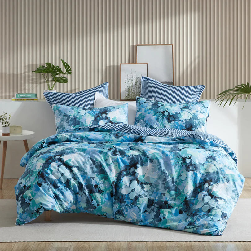 Embrace the modern allure of the Heather Quilt Cover Set Range Blue by Logan and Mason, where layers of foliage in various shades of blue come together to form this captivating design.
