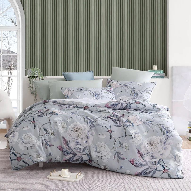 Embrace the timeless elegance of the Josie Quilt Cover Set Range Dove by Logan and Mason Platinum, as it embodies the captivating allure of a classic floral design. Delicate whispy contours and floral silhouettes grace a printed jacquard sheer fabrication, resulting in a truly unique combination that creates the illusion of texture and depth.