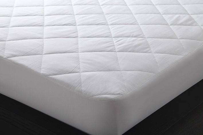 Logan & Mason presents the Pure Cotton Quilted Mattress Protector, designed to provide natural breathability and absorption.