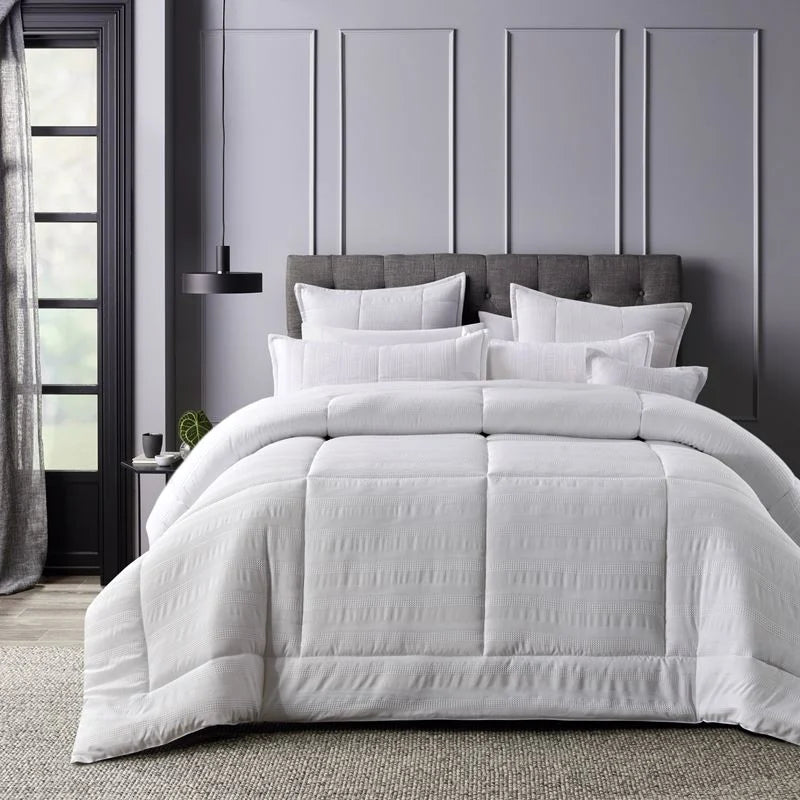 Experience the epitome of crispness, freshness, and cleanliness with the Porter White Comforter Set. This exquisite ensemble is designed to create a peaceful and comfortable space in your home, enveloping you in tranquillity and serenity.