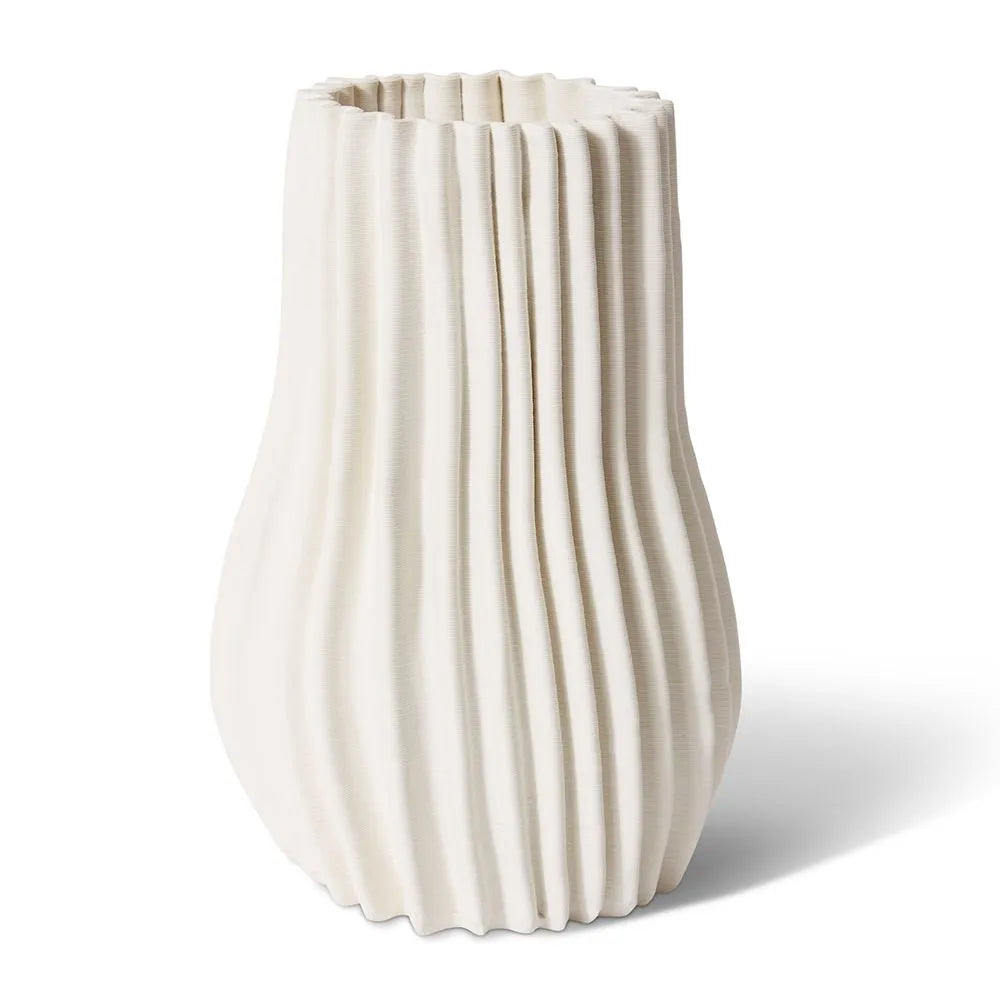 Experience a modern addition to your home decor with the Akani Vase. Crafted from 3D printed ceramic, this vase adds a unique and charming display to any interior. Enjoy its interesting features and elegant design.