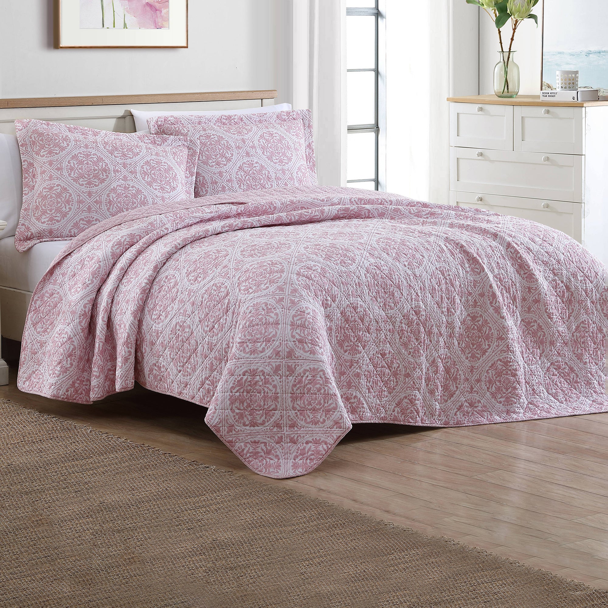 The Ayla Coverlet Set Dusted Rose by Laura Ashley features a gorgeous light pink medallion design on white ground that will add elegance to your bedroom.