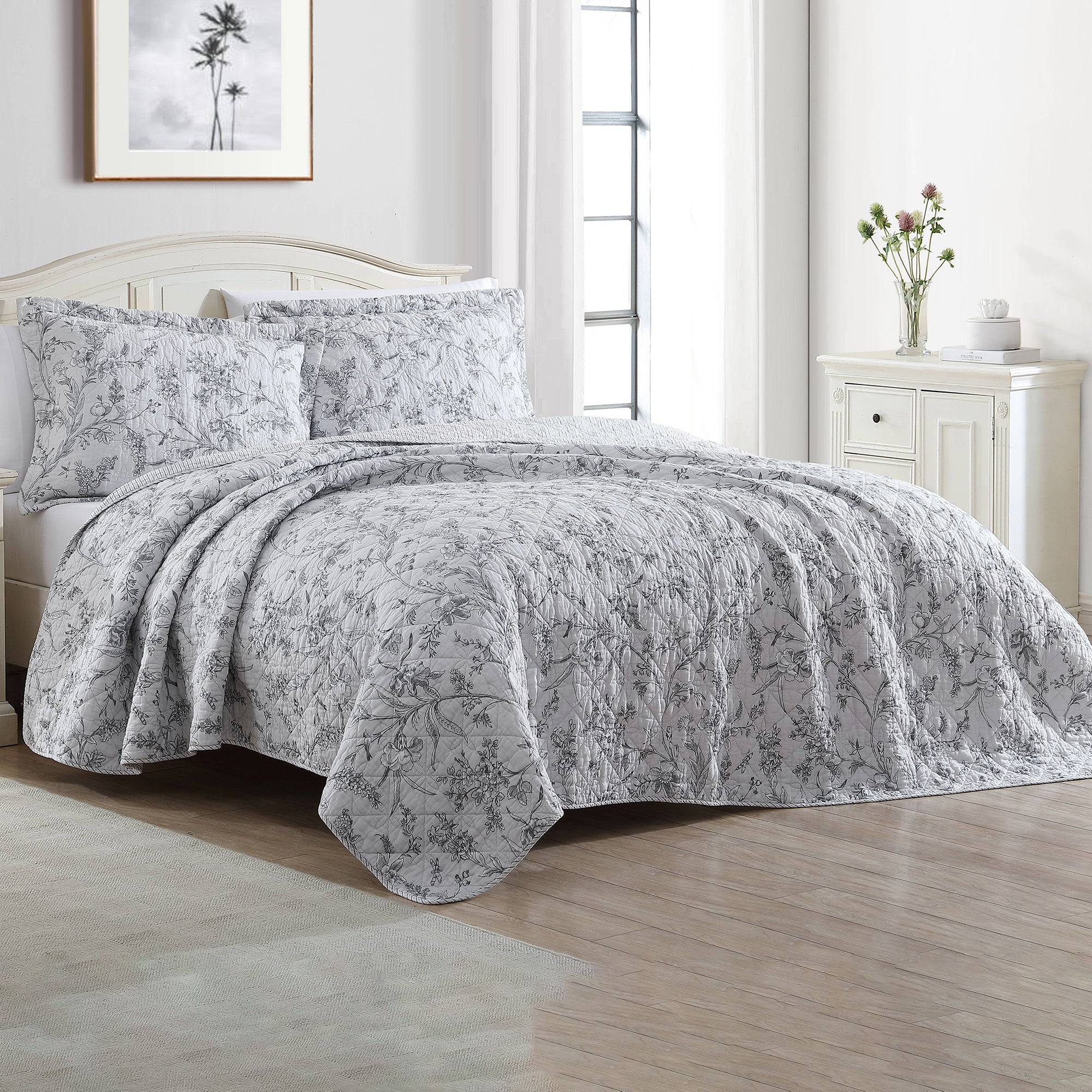 The Branch Toile Coverlet Set Grey by Laura Ashley features a grey floral design on soft white ground which is fully reversible to a delicate pinstripe design, perfect for creating versatile bedroom looks.