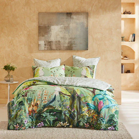 Beautiful jungle foliage and lush tropical flowers of Hibiscus and wild orchids, frame the soft green background watercolour hues. Creating the perfect sanctuary for the parrots and cockatoos to hang out. The contrast reverse print is made from line art depicting tonal hibiscus and orchids.