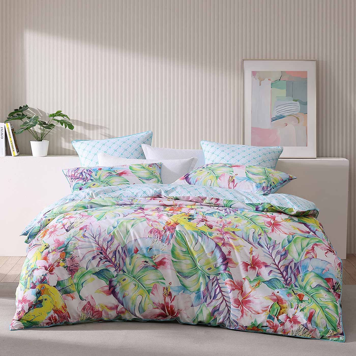 Parakeeta Aqua  uses watercolour paintings of hibiscus, palm foliage, orchids and cheeky jungle parrots to form this tropical abundance of colour. Neon pastels continue to trend for summer and dominate this design. The co ordinate reverse features the ever popular summer favourite of aqua in a micro geometric pattern.