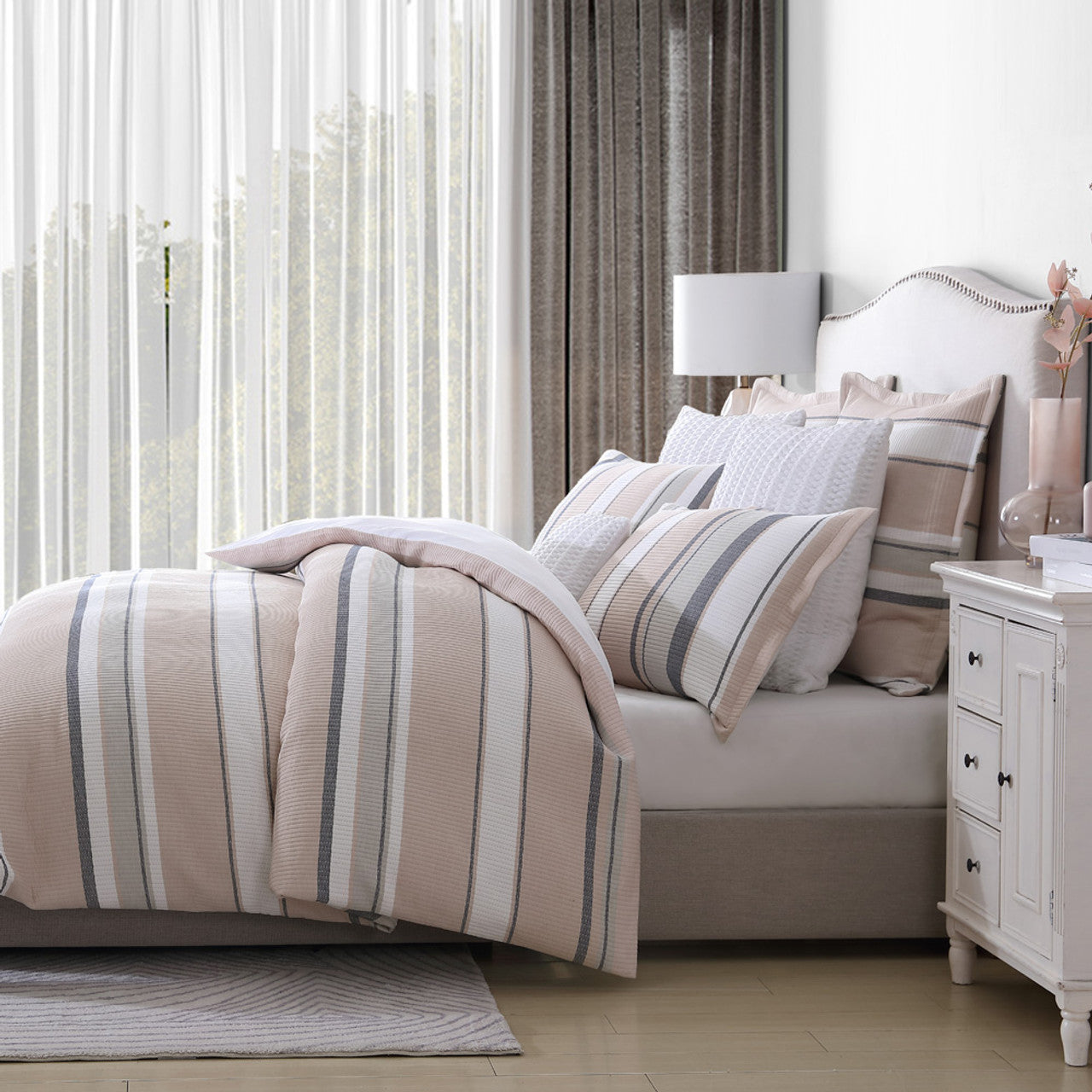 Experience a touch of laid-back sophistication with the Private Collection killarney dune bed quilt cover set. This exquisite set boasts relaxed stripes, perfect for capturing the essence of a stylish summer. The variegated stripes in serene shades of chambray, dune, and avocado effortlessly blend together on the luxuriously soft matelassé fabric. 