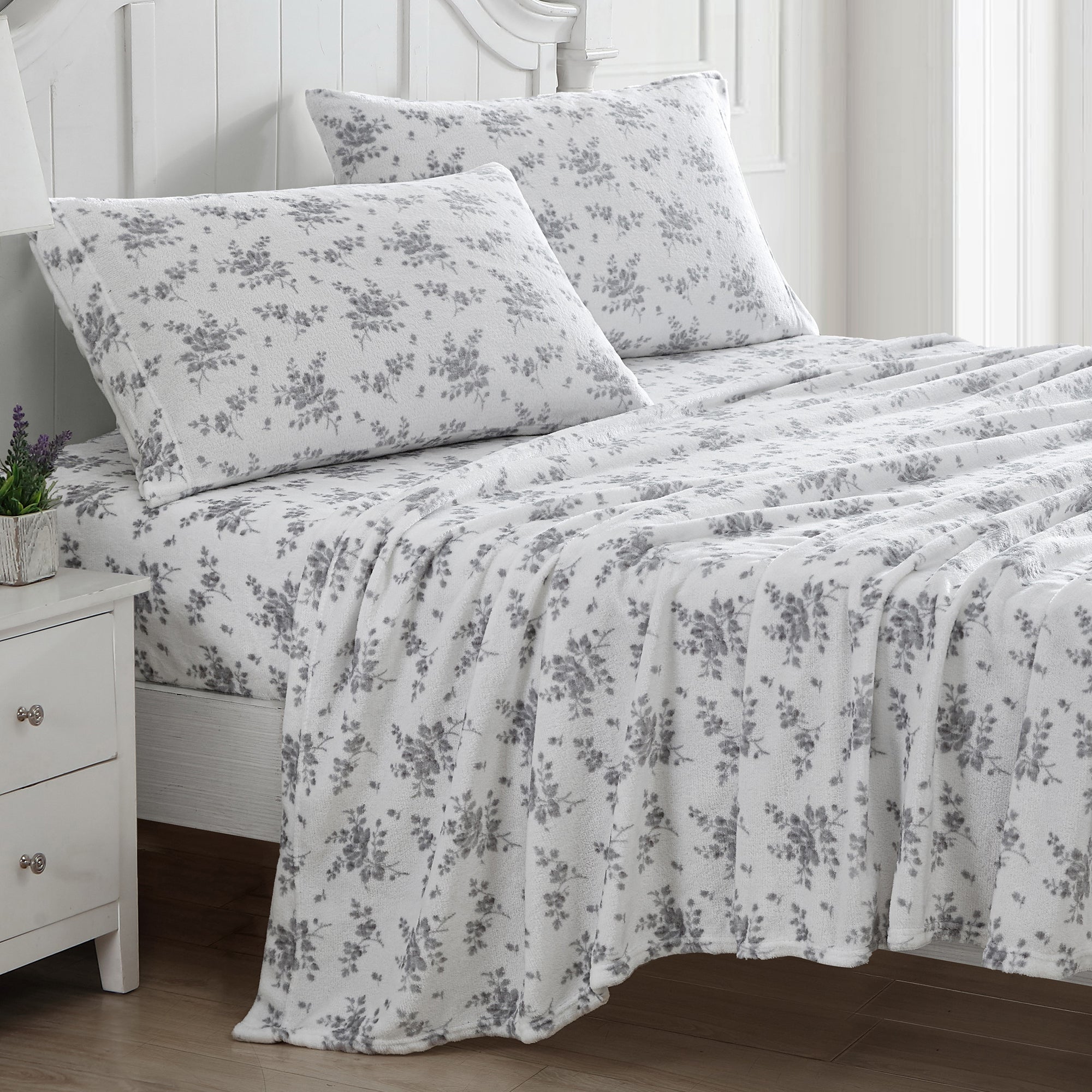 Cherish the timeless florals and warm embrace of the Laura Ashley Rachel Flannel Fleece Sheet Set Silver.