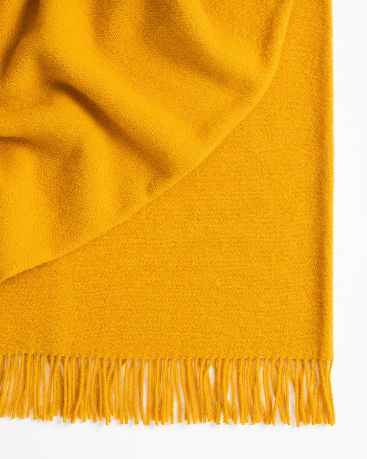 Made from 100% New Zealand lambswool, Nevis throw blankets in saffron are simply luxurious. All of our throws make the perfect companion over cooler days and nights, and can also be enjoyed outdoors