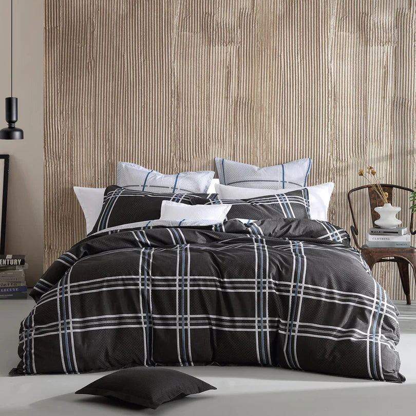 Experience the versatility of the Charlie Quilt Cover Set Range Black by Logan and Mason. This range creatively combines classic checks and houndstooth patterns with a modern twist, using varying scales and a sophisticated, adaptable color palette