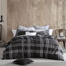 Experience the versatility of the Charlie Quilt Cover Set Range Black by Logan and Mason. This range creatively combines classic checks and houndstooth patterns with a modern twist, using varying scales and a sophisticated, adaptable color palette