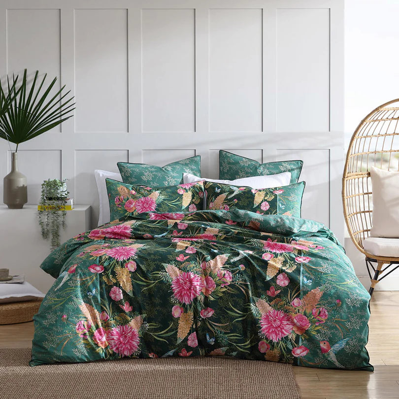 Experience the enchantment of the Frolic Quilt Cover Set Range Jade by Logan and Mason, where vibrant blooms and delightful hummingbirds come together in a whimsical design